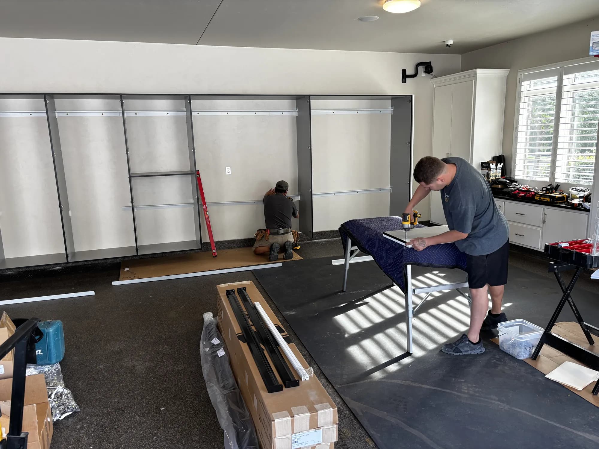 Closet 1 installers assembling a custom garage storage system
