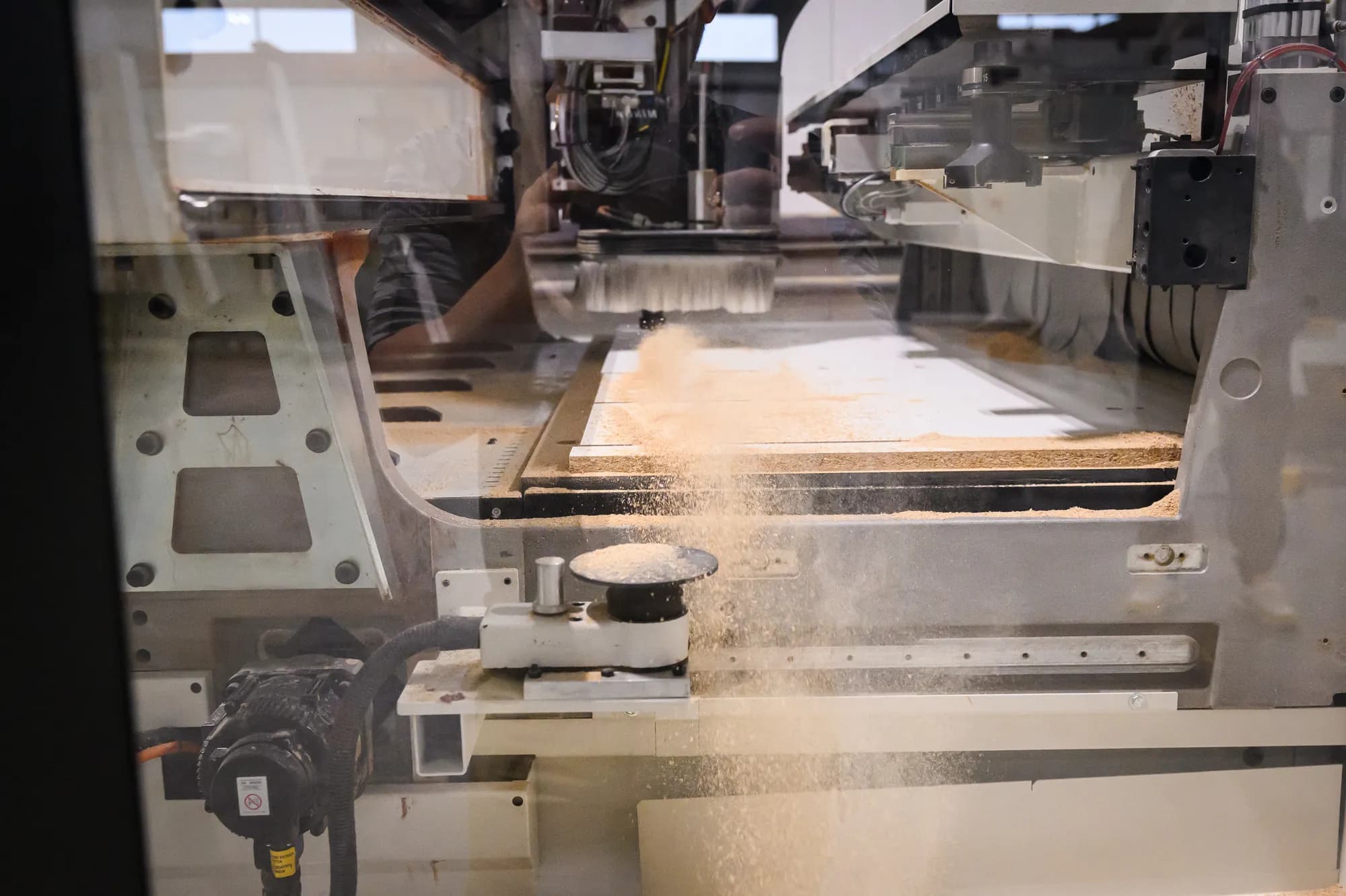 A CNC router cutting a closet panel to size